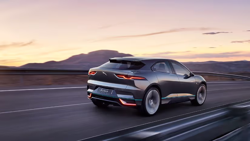 A Jaguar races across a mountainous desert