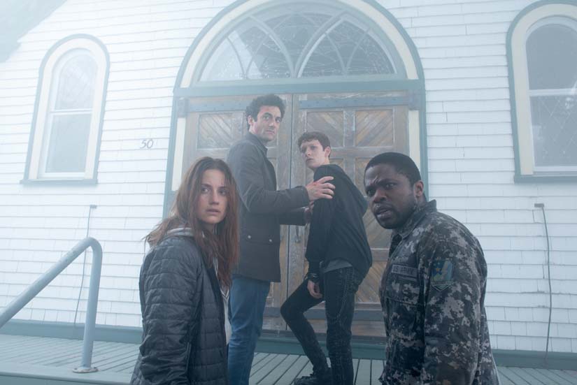 4 people look behind them as they enter a church