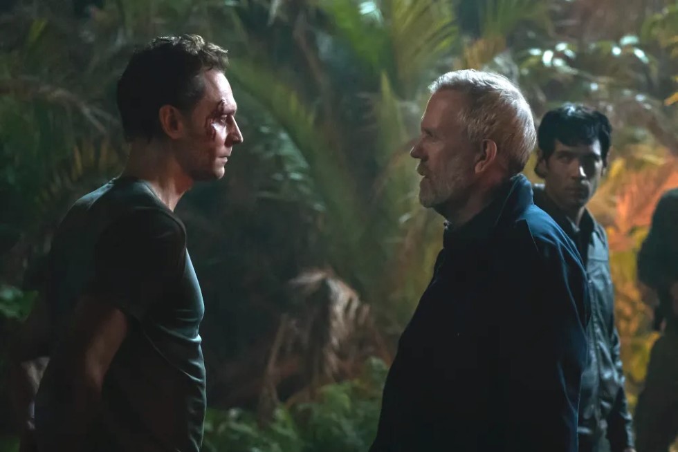 Production still from The Night Manager Season 2 — Pine and Teddy in the night office scene
