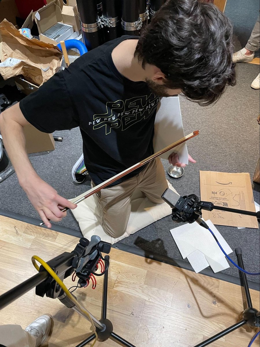 Bowing a prop with a violin bow during a Saros recording session