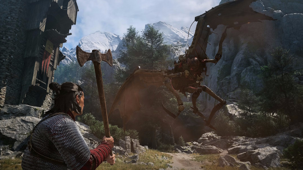 Coen with an axe faces a giant winged wooden creature in a mountain pass