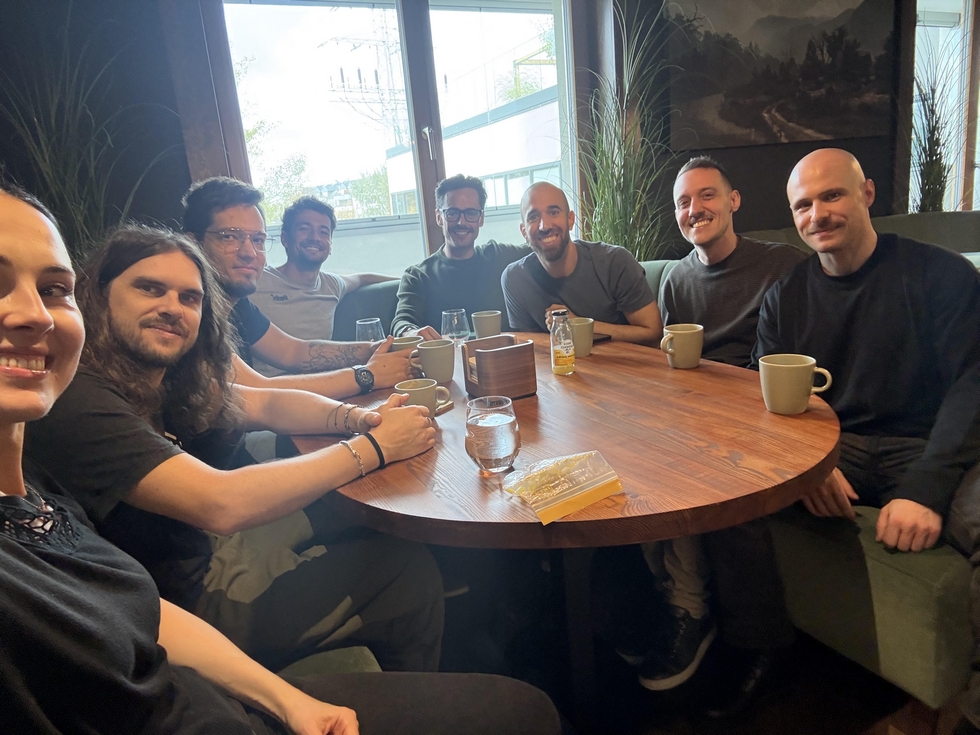 The game audio team gathered around a café table